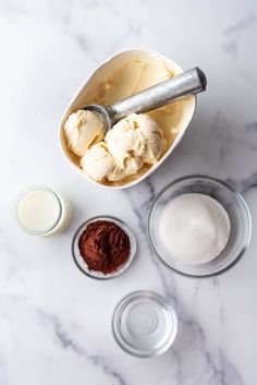 ingredients for making ice cream in bowls on a marble surface