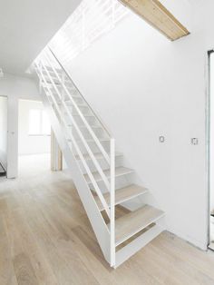 an empty room with stairs leading up to the second floor