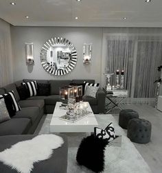 a living room filled with furniture and a large mirror on the wall above it's fireplace