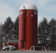 two large red silos sitting next to each other