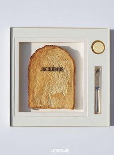 a piece of bread in a box with the word acuremus written on it