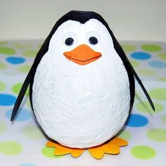 a close up of a toy penguin on a table