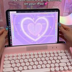 two hands holding an open laptop computer with a heart on the screen and words above it