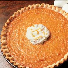 an orange pie with whipped cream on top