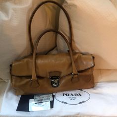 Sughero (Cork) Colored Prada Calfskin Bag This Bag Is Pre-Owned And Shows Signs Of Use But Is In Good Overall Condition. See Images For Detail. This Bag Has No Major Flaws And Is Free From Rips Or Tears. Certificate Of Authenticity And Dust Bag Are Included. Leather Flap Satchel, Luxury Flap Satchel With Silver-tone Hardware, Luxury Satchel With Silver-tone Hardware And Flap, Brown Calf Leather Satchel With Dust Bag, Luxury Satchel With Soft Leather And Flap, Luxury Soft Leather Satchel With Flap, Leather Flap Satchel For Shopping, Brown Designer Bag, Prada Hobo Bag