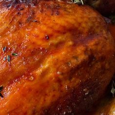 a close up view of a cooked chicken with herbs on it's head and sides