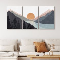 three paintings on the wall in a living room