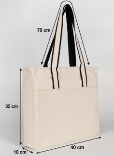 a white tote bag with black handles and measurements for the bottom part of it