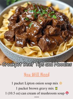 a bowl filled with beef and noodles on top of a wooden table