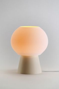 a white lamp sitting on top of a table