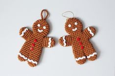 two crocheted gingerbreads hanging from strings