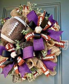 the football wreath is decorated with burluck and purple ribbon, it's ready to be hung on the front door