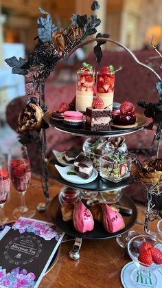 an assortment of desserts and pastries displayed on a table in a fancy setting