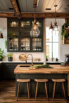 a kitchen with two stools and an island in the middle, surrounded by potted plants