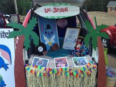 the trunk of a car is decorated with pictures and palm trees for children's birthday