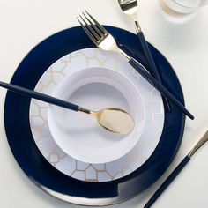 a white and blue plate topped with silverware