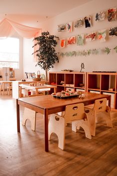 a wooden table and chairs in a room