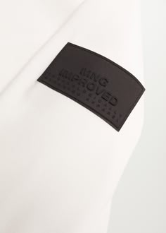 a white shirt with a black label on it