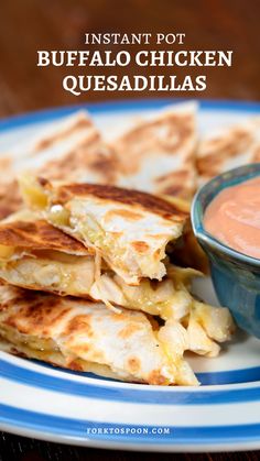 some quesadillas on a plate with a bowl of salsa