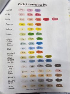 the color chart for copic ink is displayed on a piece of paper with scissors