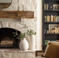 a living room filled with furniture and a fire place next to a bookshelf