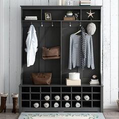 a black and white coat rack with shoes, purses and other items on it