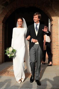 the bride and groom are walking down the aisle