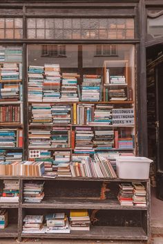 there are many books on the shelves in this book store front window, all stacked up and ready to be read