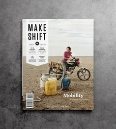 a magazine cover with a man sitting on a motorcycle in the middle of desert land