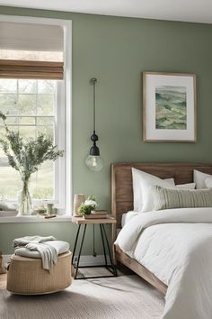 a bedroom with green walls and white bedding