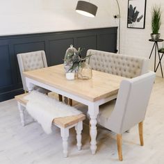 a dining room table with two chairs and a bench