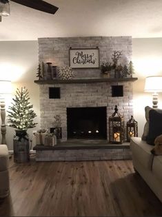 a living room filled with furniture and a fire place in the middle of it's wall