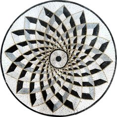 a black and white mosaic design with an eye in the center