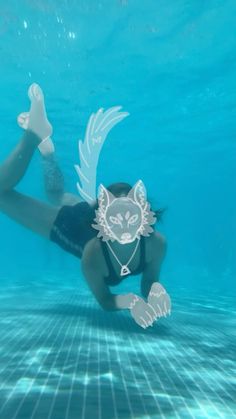 a woman in a swimsuit floating under water