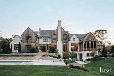 a large white house with a pool in the front yard and lots of windows on each side