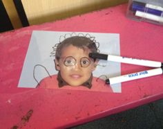 a child's face is taped to a piece of paper