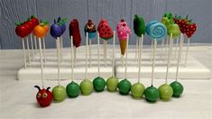 an assortment of fruit and vegetable lollipops arranged in the shape of a caterpillar