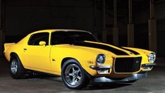 a yellow muscle car parked in a garage