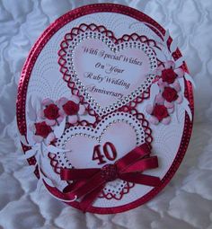 an anniversary card with roses and hearts on it, in the shape of a heart