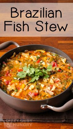 a pan filled with fish stew and garnished with cilantro