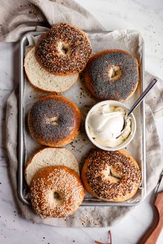 bagels with cream cheese and sprinkles on a tray