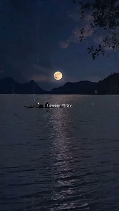 a full moon is seen in the sky over water with boats floating on it's surface