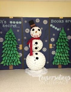 a snowman made out of toilet paper sitting in front of two bookshelves