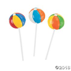 three beach ball lollipops sitting on top of each other