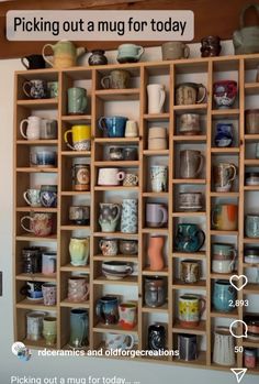 a wooden shelf filled with lots of cups and mugs