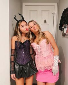 two women dressed up in costumes posing for the camera