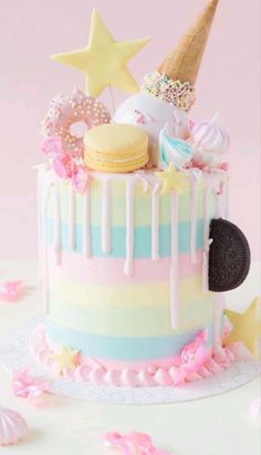 there is a colorful cake with ice cream and cookies on the top that has stars around it