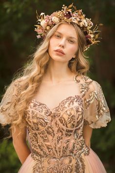 a woman wearing a dress with flowers in her hair and a crown on her head