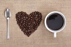 coffee beans and spoon on burlap surface with sacking pattern, top view