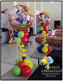 mickey mouse balloon decorations in the middle of a room